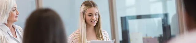 Eine Praktikantin hält vor Menschen einen Vortrag